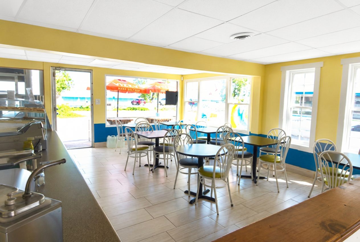 Bayview dining room with beach view through open patio doors