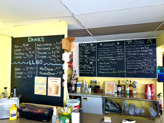 Chalkboard menu featuring drinks, fries, sandwiches and mains