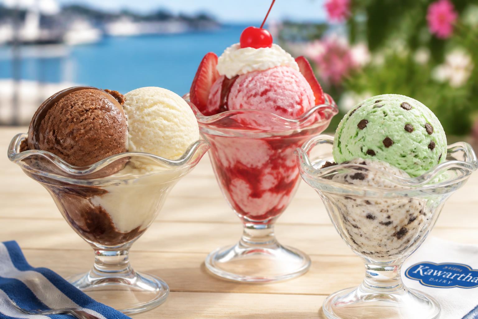 Premium hard scoop ice cream served in glass sundae cups — chocolate and vanilla, strawberry sundae with whipped cream, and mint chocolate chip with cookies & cream